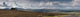 A Road Leading Into The Distance And Dramatic Clouds Over A Landscape Wall Mural