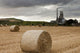A Cement Production Plant With Hay Bales In A Field In The Foreground Wall Mural