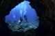 USA, Hawaii Islands, Divers At Entrance To Lava Tube Wall Mural