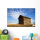 A Wooden Shed Stands Alone In A Snow Covered Field Wall Mural