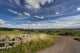A Country Road With A Hilly Landscape Wall Mural