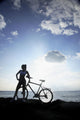 Hawaii, Oahu, Silhouette Of A Woman With A Bike On A Rocky Coastline Wall Mural