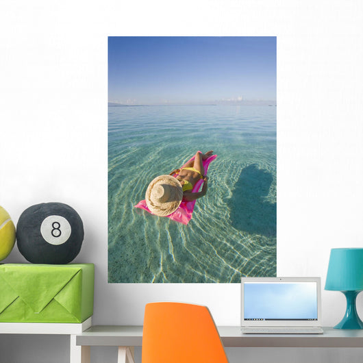 French Polynesia, Tahiti, Moorea, Woman Floating In Water Wall Mural