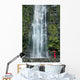 Woman Stands With Umbrella At The Base Of Waterfall Wall Mural