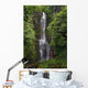 Woman Stands With Umbrella At Wailua Falls Surrounded By Foliage Wall Mural