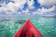 Red Outrigger Canoe In Calm Turquoise Water Wall Mural