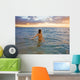 Hawaii, Kauai, Woman Walking In The Ocean As The Sun Sets Wall Mural