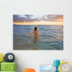 Hawaii, Kauai, Woman Walking In The Ocean As The Sun Sets Wall Mural