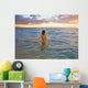 Hawaii, Kauai, Woman Walking In The Ocean As The Sun Sets Wall Mural