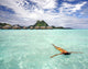 Woman Floating In Water Near Resort Wall Mural