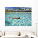 French Polynesia, Moorea, Woman Free Diving In Turquoise Ocean Wall Mural