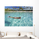 French Polynesia, Moorea, Woman Free Diving In Turquoise Ocean Wall Mural