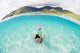 French Polynesia, Moorea, Woman Free Diving In Turquoise Ocean Wall Mural