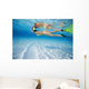 French Polynesia, Moorea, Woman Free Diving In Turquoise Ocean Wall Mural