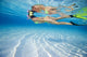 French Polynesia, Moorea, Woman Free Diving In Turquoise Ocean Wall Mural
