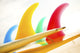 Colorful Surfboards Fins, Bright Sunny Sky In Background Wall Mural