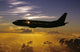 USA, Silhouette of airplane in sunset sky Wall Mural