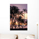 Palm trees and a couple in beach chairs at sunset at Anaehoomalu Bay Wall Mural