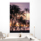Palm trees and a couple in beach chairs at sunset at Anaehoomalu Bay Wall Mural