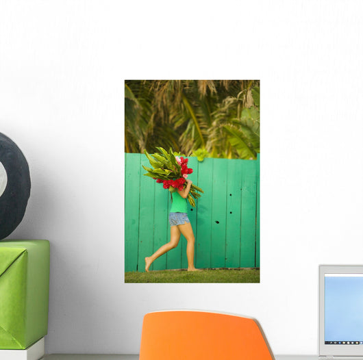 Woman holding red and pink ginger flowers Wall Mural