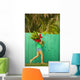 Woman holding red and pink ginger flowers Wall Mural