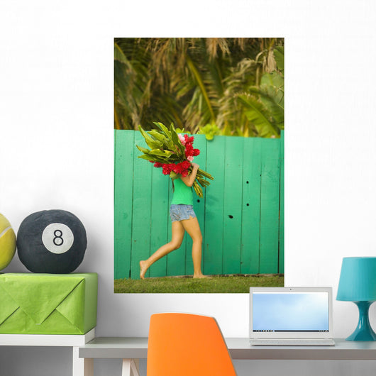 Woman holding red and pink ginger flowers Wall Mural