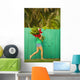 Woman holding red and pink ginger flowers Wall Mural