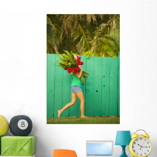 Woman holding red and pink ginger flowers Wall Mural