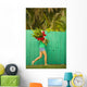 Woman holding red and pink ginger flowers Wall Mural