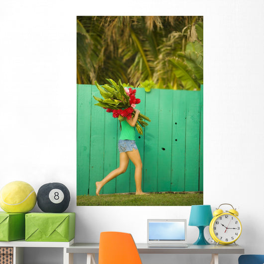Woman holding red and pink ginger flowers Wall Mural