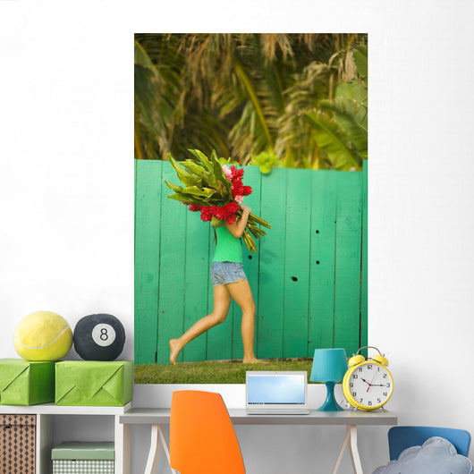 Woman holding red and pink ginger flowers Wall Mural