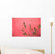 A Pink Flowering Plant Growing Beside A Red Wall Wall Mural