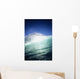 Closeup angle of green wave with backlit crest, bright blue sky Wall Mural