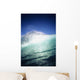 Closeup angle of green wave with backlit crest, bright blue sky Wall Mural