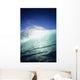 Closeup angle of green wave with backlit crest, bright blue sky Wall Mural