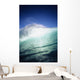 Closeup angle of green wave with backlit crest, bright blue sky Wall Mural
