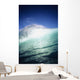Closeup angle of green wave with backlit crest, bright blue sky Wall Mural