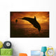 A Pair Of Atlantic Bottlenose Dolphin Leap Into A Caribbean Sunset Wall Mural