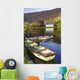 St Finbarre's Oratory And Rowing Boats On Shore Of Gougane Barra Lake Wall Mural