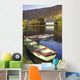 St Finbarre's Oratory And Rowing Boats On Shore Of Gougane Barra Lake Wall Mural