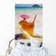Mai Tai Getting Splashed By A Wave As It Rest On The Beach Wall Mural
