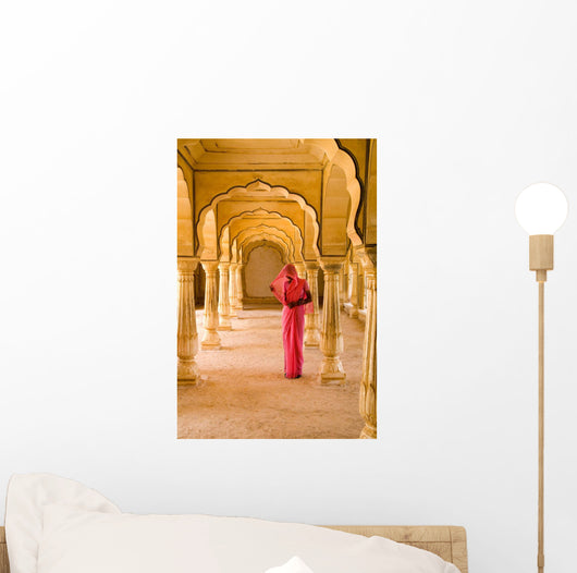 Woman In Bright Pink Sari Stands Beneath Arches Wall Mural