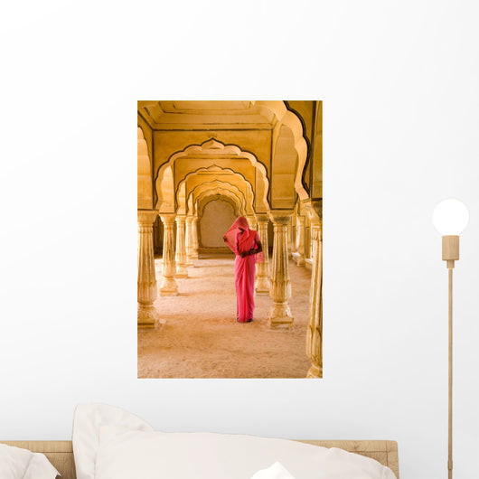 Woman In Bright Pink Sari Stands Beneath Arches Wall Mural