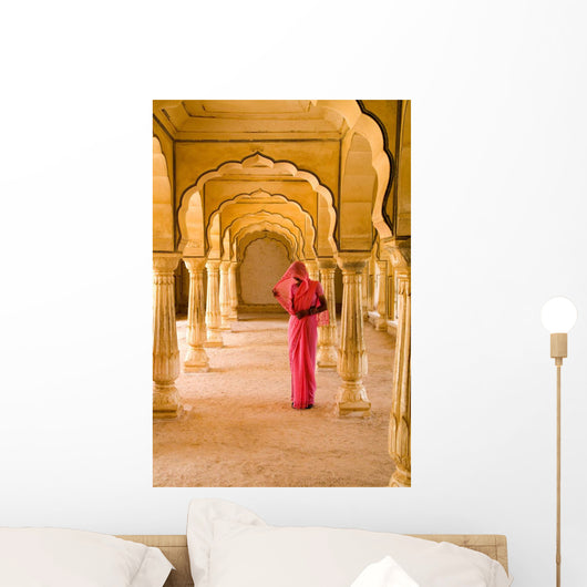 Woman In Bright Pink Sari Stands Beneath Arches Wall Mural