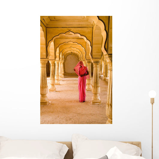 Woman In Bright Pink Sari Stands Beneath Arches Wall Mural