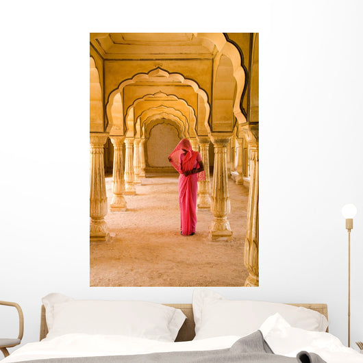 Woman In Bright Pink Sari Stands Beneath Arches Wall Mural