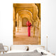 Woman In Bright Pink Sari Stands Beneath Arches Wall Mural