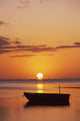 Sun Setting Over Ocean, Boat Silhouetted Against Orange Sky Wall Mural