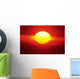 Gorgeous Sun Setting In Bright Orange Sky Over Ocean Wall Mural