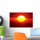 Gorgeous Sun Setting In Bright Orange Sky Over Ocean Wall Mural